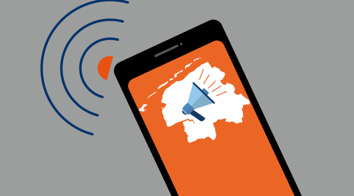 Grafische Darstellung eines Smartphones mit orangefarbenem Bildschirm. Darauf ist die Umrisskarte des Landkreises Aurich mit einem Megafon abgebildet. Seitlich vom Handy sind blaue Schallwellen dargestellt, die eine Benachrichtigung oder Warnmeldung symbolisieren.